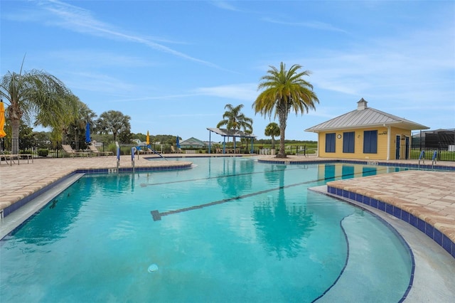 981 Fiesta Key Cir, Lady Lake, FL 32159 - community pool featuring a patio area