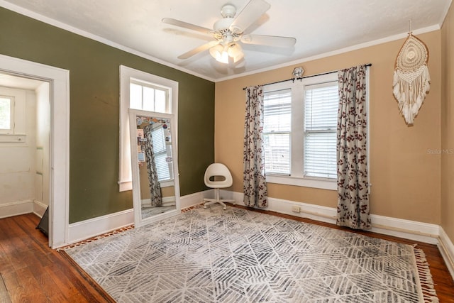 unfurnished room with baseboards, plenty of natural light, wood finished floors, and ornamental molding