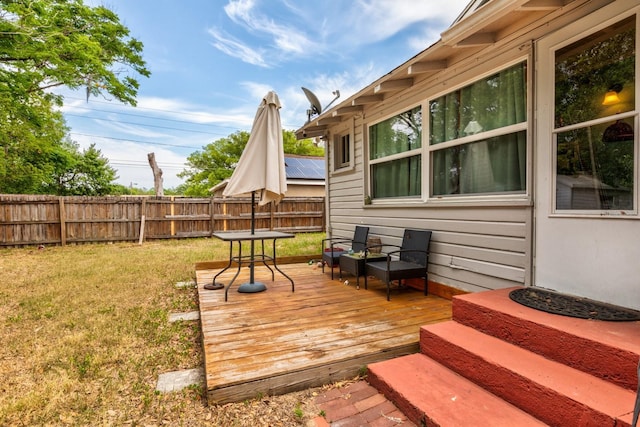 deck featuring a lawn, fence, and an outdoor hangout area