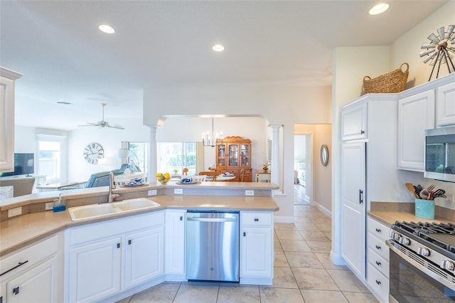 1046 Ridgeland Path, The Villages, FL 32162 - kitchen with ornate columns, light countertops, a sink, and appliances with stainless steel finishes