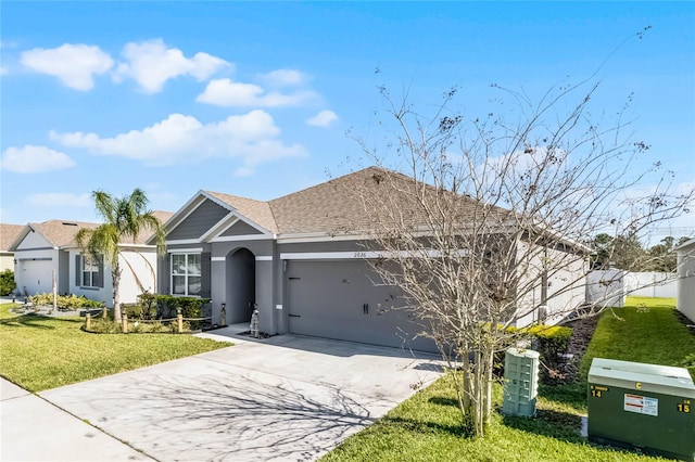 2636 Neverland Dr, New Smyrna Beach, FL 32168 - ranch-style home featuring stucco siding, driveway, a front lawn, roof with shingles, and a garage