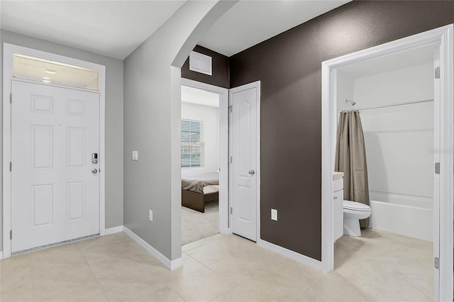 2636 Neverland Dr, New Smyrna Beach, FL 32168 - foyer entrance with arched walkways, visible vents, baseboards, and light tile patterned floors