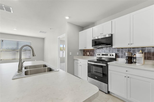 2636 Neverland Dr, New Smyrna Beach, FL 32168 - kitchen with visible vents, backsplash, light countertops, appliances with stainless steel finishes, and a sink