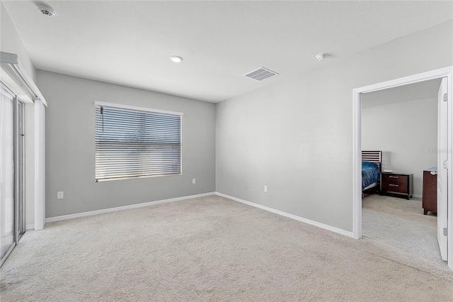 2636 Neverland Dr, New Smyrna Beach, FL 32168 - unfurnished bedroom featuring visible vents, baseboards, and carpet flooring