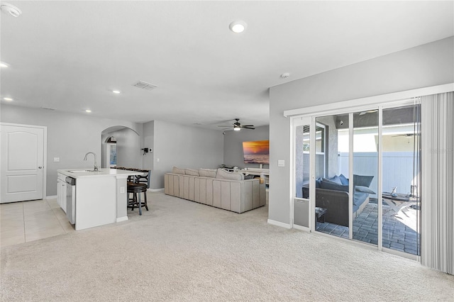 2636 Neverland Dr, New Smyrna Beach, FL 32168 - living area featuring visible vents, ceiling fan, light colored carpet, recessed lighting, and arched walkways