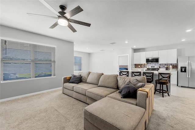 2636 Neverland Dr, New Smyrna Beach, FL 32168 - living area featuring light carpet, recessed lighting, baseboards, and ceiling fan