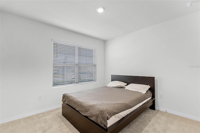 2636 Neverland Dr, New Smyrna Beach, FL 32168 - bedroom featuring light colored carpet and baseboards