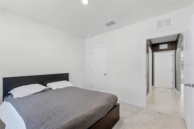 2636 Neverland Dr, New Smyrna Beach, FL 32168 - bedroom with light tile patterned floors, light colored carpet, visible vents, and baseboards