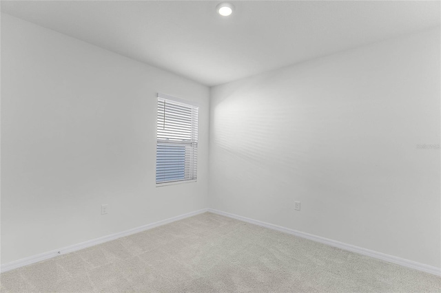 2636 Neverland Dr, New Smyrna Beach, FL 32168 - spare room featuring light carpet and baseboards