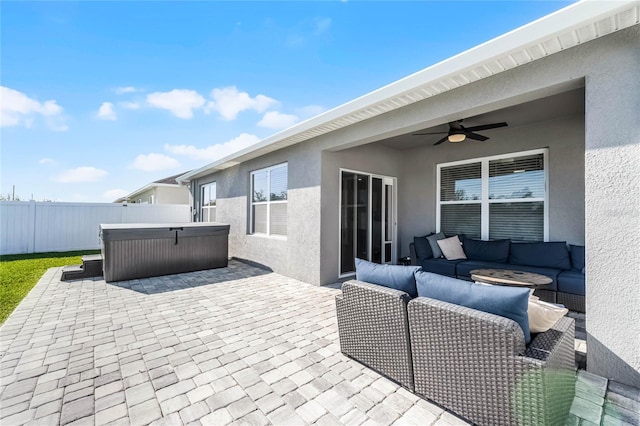 2636 Neverland Dr, New Smyrna Beach, FL 32168 - view of patio / terrace with an outdoor hangout area, a hot tub, a ceiling fan, and fence