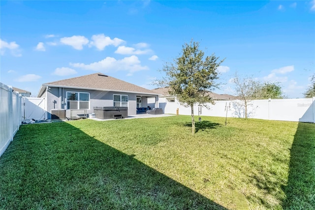 2636 Neverland Dr, New Smyrna Beach, FL 32168 - exterior space with a hot tub, stucco siding, a yard, a fenced backyard, and a patio area