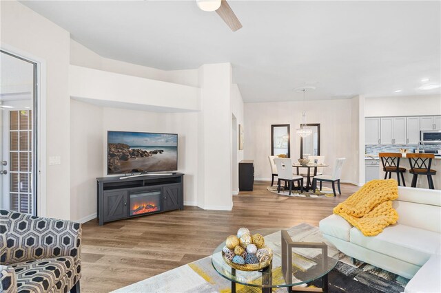6152 Topsail Rd, Lady Lake, FL 32159 - living room featuring baseboards, ceiling fan, and wood finished floors