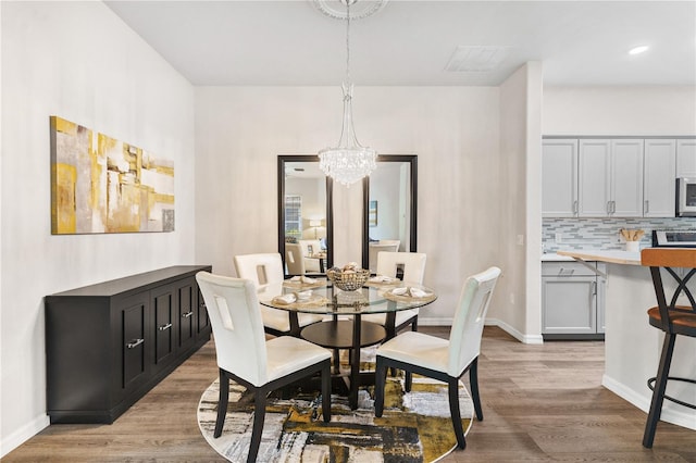6152 Topsail Rd, Lady Lake, FL 32159 - dining space with visible vents, baseboards, a chandelier, and wood finished floors