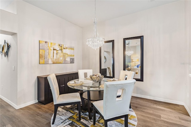 6152 Topsail Rd, Lady Lake, FL 32159 - dining space with baseboards, wood finished floors, and a chandelier