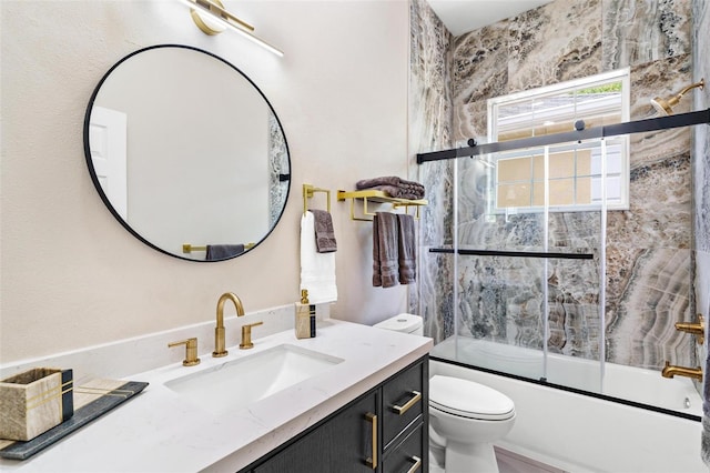 6152 Topsail Rd, Lady Lake, FL 32159 - bathroom featuring toilet, vanity, and bath / shower combo with glass door
