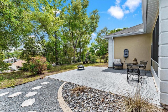 6152 Topsail Rd, Lady Lake, FL 32159 - view of patio / terrace with an outdoor fire pit