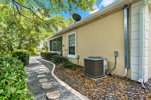 6152 Topsail Rd, Lady Lake, FL 32159 - view of side of home with stucco siding and cooling unit