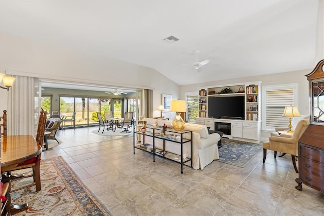 living room featuring visible vents, lofted ceiling, and a ceiling fan