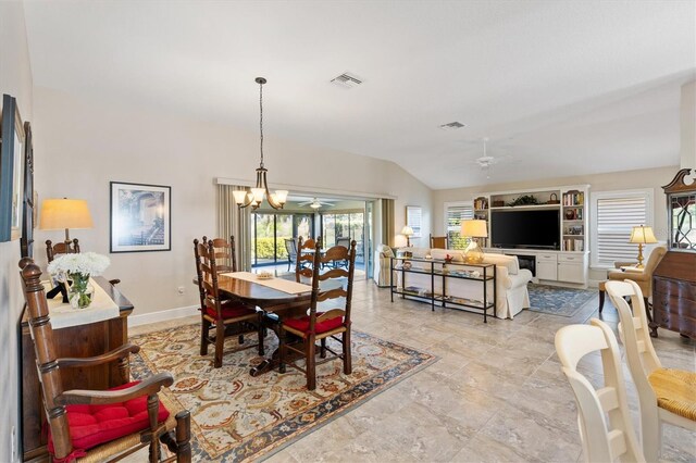 dining space featuring lofted ceiling, ceiling fan with notable chandelier, visible vents, and baseboards