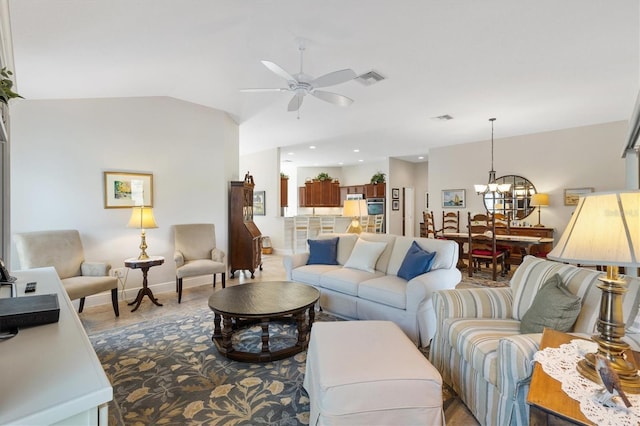 living room featuring visible vents, baseboards, lofted ceiling, ceiling fan with notable chandelier, and wood finished floors