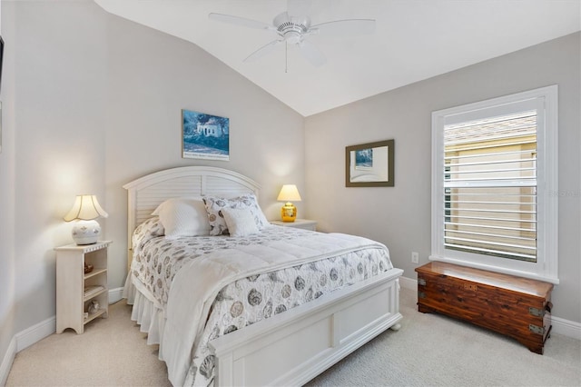 bedroom featuring vaulted ceiling, a ceiling fan, baseboards, and light carpet