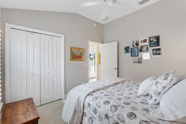 carpeted bedroom featuring a closet, visible vents, ceiling fan, and lofted ceiling
