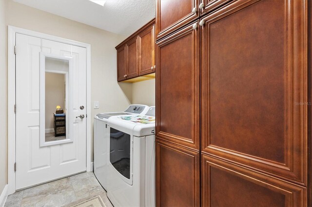laundry room featuring washer and clothes dryer and cabinet space