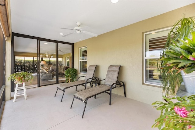 sunroom featuring a ceiling fan