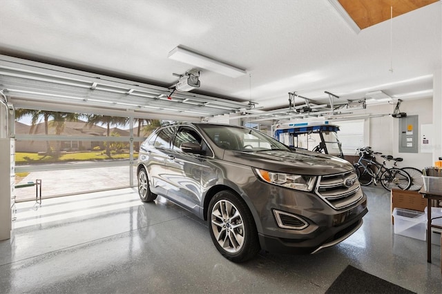 garage with electric panel and a garage door opener