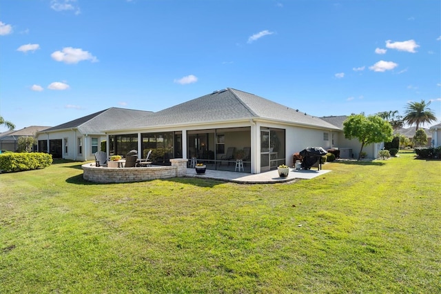 back of house with a yard, stucco siding, a patio, and a sunroom