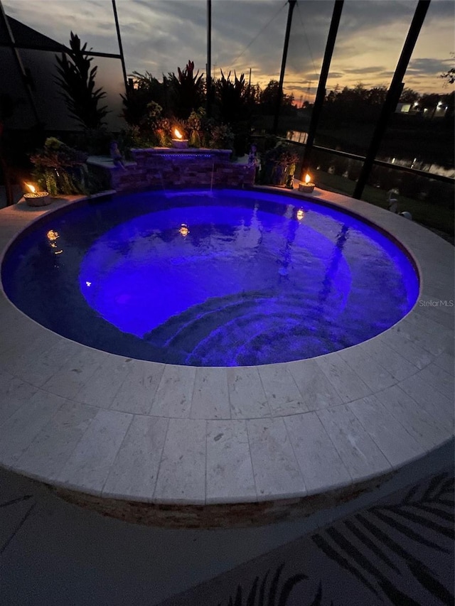 6444 Mcknight Loop, The Villages, FL 34762 - pool at dusk with a jacuzzi, a lanai, and an outdoor pool