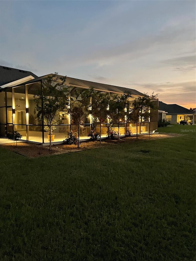 6444 Mcknight Loop, The Villages, FL 34762 - back of property with a lawn and glass enclosure