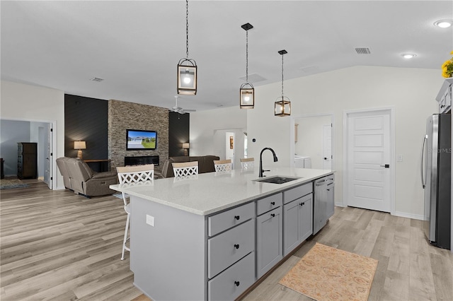 6444 Mcknight Loop, The Villages, FL 34762 - kitchen with a sink, appliances with stainless steel finishes, light wood-style floors, light countertops, and vaulted ceiling