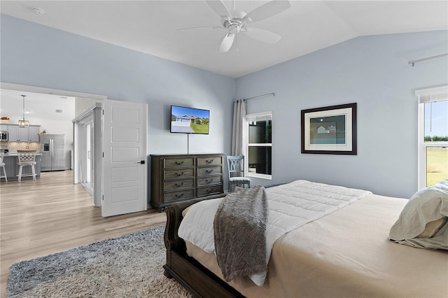 6444 Mcknight Loop, The Villages, FL 34762 - bedroom with stainless steel fridge, light wood-style flooring, lofted ceiling, and ceiling fan