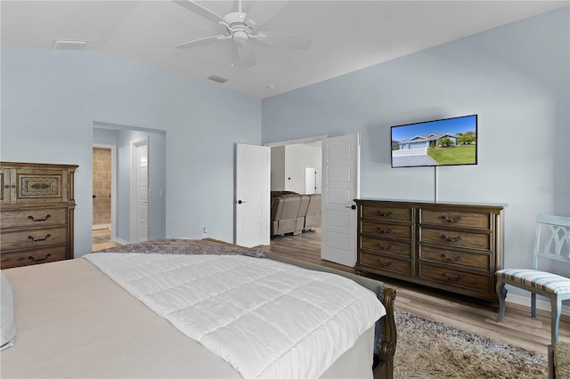 6444 Mcknight Loop, The Villages, FL 34762 - bedroom with wood finished floors, lofted ceiling, ensuite bath, and a ceiling fan
