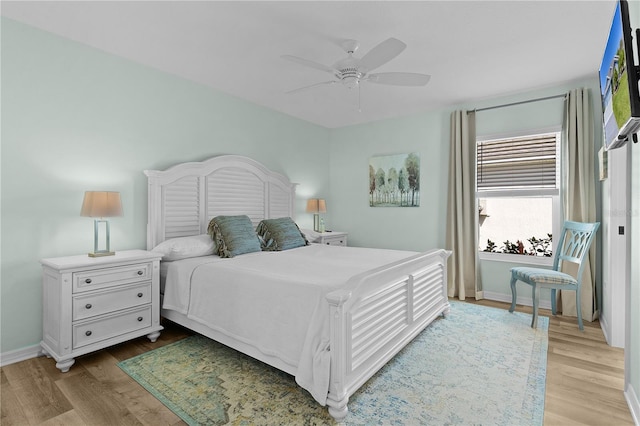 6444 Mcknight Loop, The Villages, FL 34762 - bedroom with wood finished floors, baseboards, and a ceiling fan