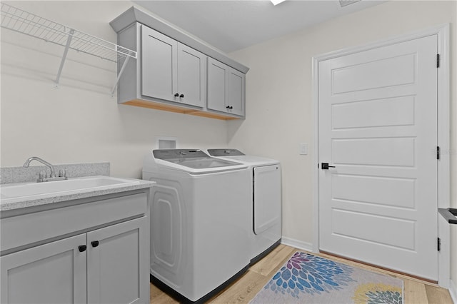 6444 Mcknight Loop, The Villages, FL 34762 - laundry area with washer and clothes dryer, light wood-style floors, and cabinet space