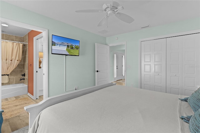 6444 Mcknight Loop, The Villages, FL 34762 - bedroom featuring wood finished floors, a closet, ceiling fan, connected bathroom, and baseboards