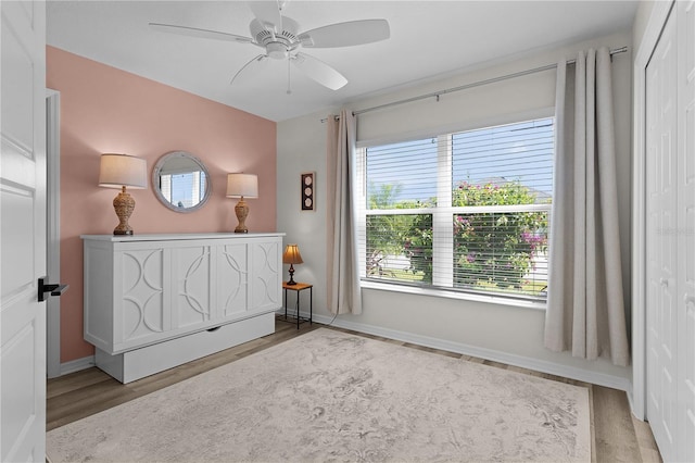 6444 Mcknight Loop, The Villages, FL 34762 - bedroom featuring wood finished floors, a closet, a ceiling fan, and baseboards