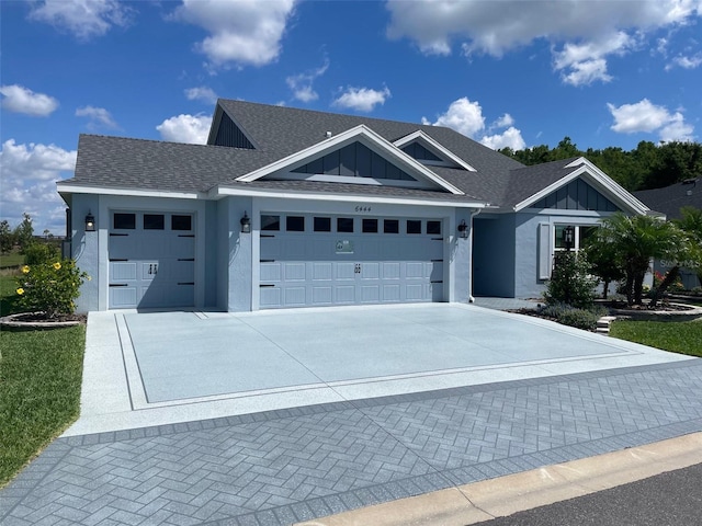 6444 Mcknight Loop, The Villages, FL 34762 - view of front of property featuring an attached garage, driveway, board and batten siding, stucco siding, and roof with shingles