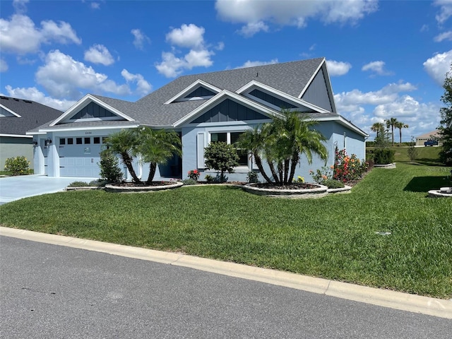 6444 Mcknight Loop, The Villages, FL 34762 - view of front of property featuring board and batten siding, an attached garage, a front lawn, driveway, and a shingled roof