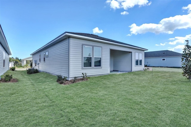 rear view of house featuring a yard