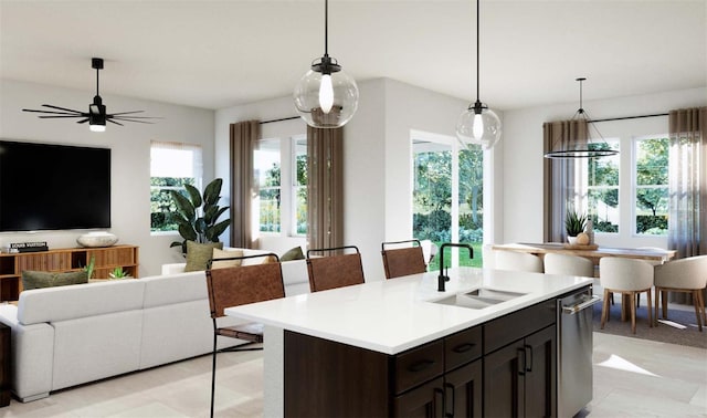 kitchen with light countertops, open floor plan, and a sink
