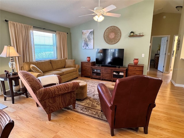 living area featuring ceiling fan, baseboards, light wood-style flooring, and lofted ceiling