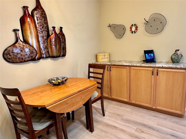 dining space featuring light wood finished floors