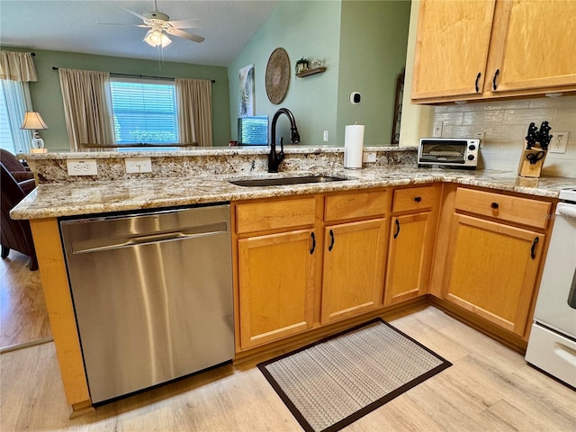 kitchen featuring a sink, tasteful backsplash, light stone countertops, dishwasher, and ceiling fan