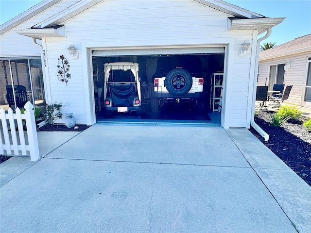 garage featuring concrete driveway