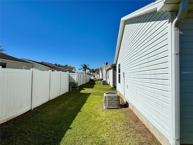 view of yard with cooling unit, a residential view, and a fenced backyard