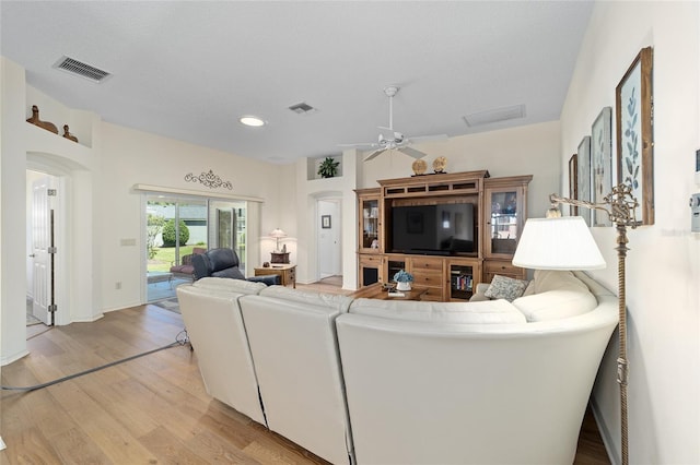 1417 Forest Acres Dr, The Villages, FL 32162 - living area featuring light wood-style floors, arched walkways, and visible vents