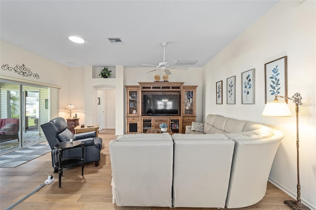 1417 Forest Acres Dr, The Villages, FL 32162 - living room featuring ceiling fan, visible vents, arched walkways, and light wood-style flooring